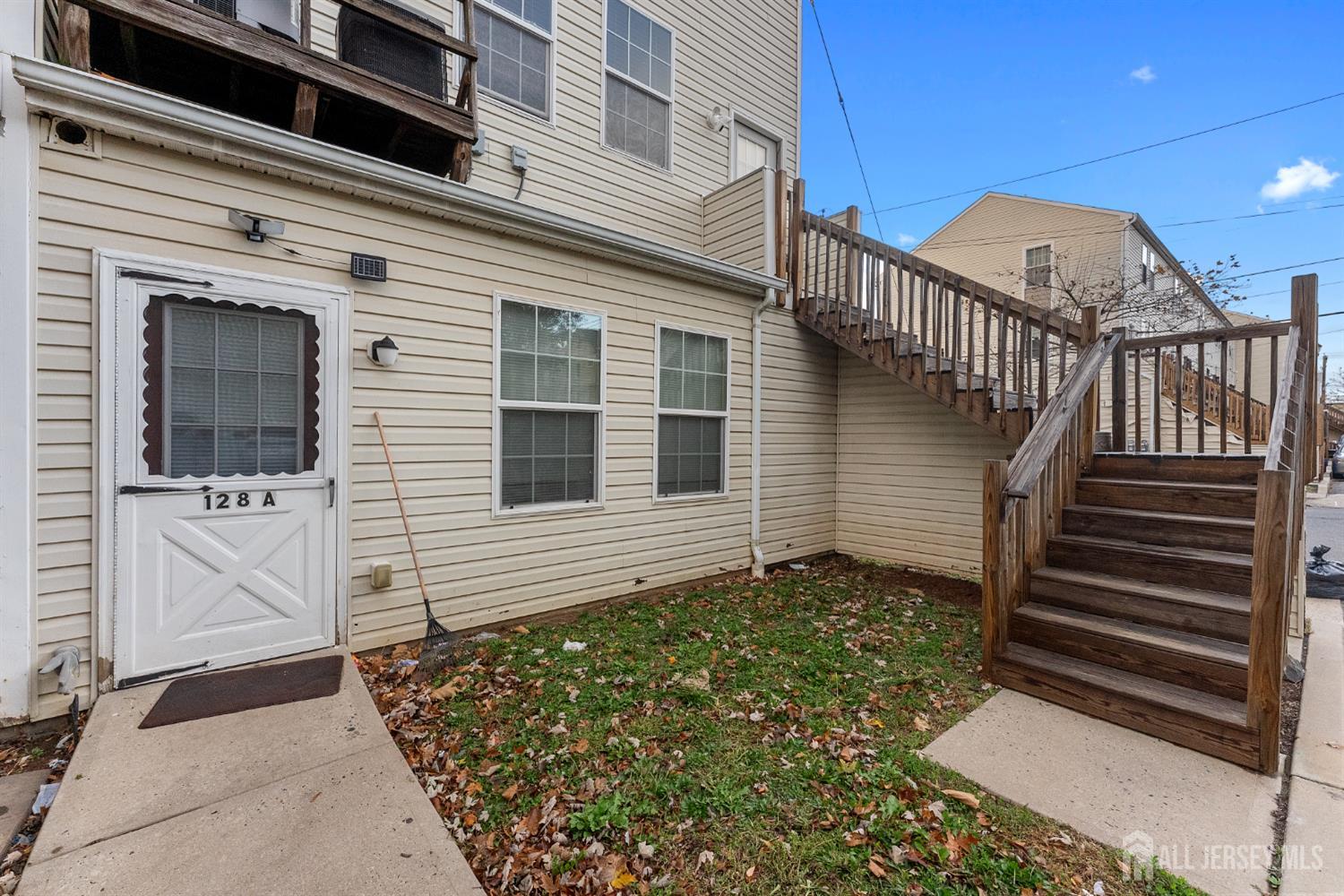 128 Remsen Avenue, Unit A New Brunswick, NJ 08901 - Photo 14 of 18 a view of a house with wooden door and a window