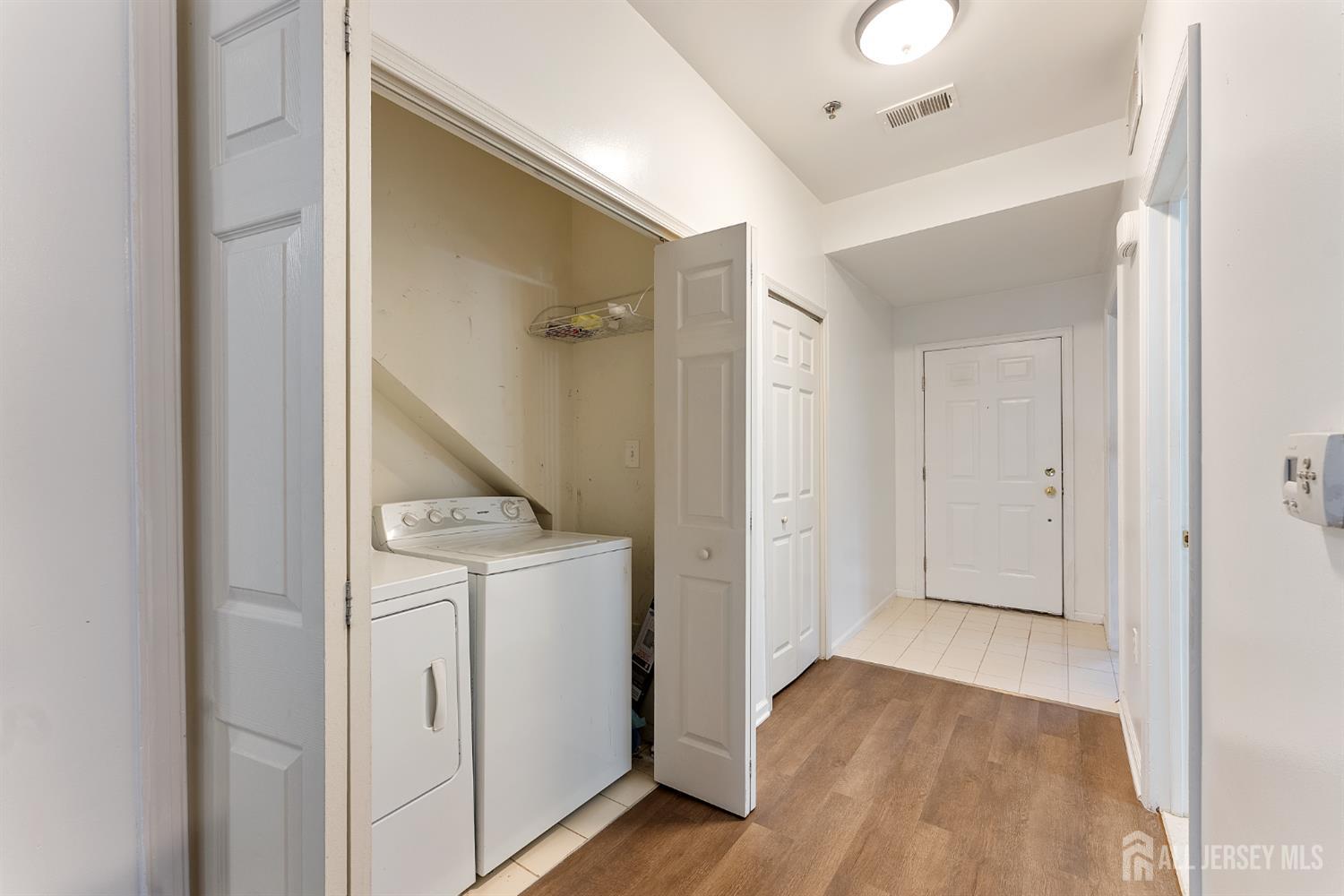 128 Remsen Avenue, Unit A New Brunswick, NJ 08901 - Photo 4 of 18 a view of a hallway with closet and wooden floor