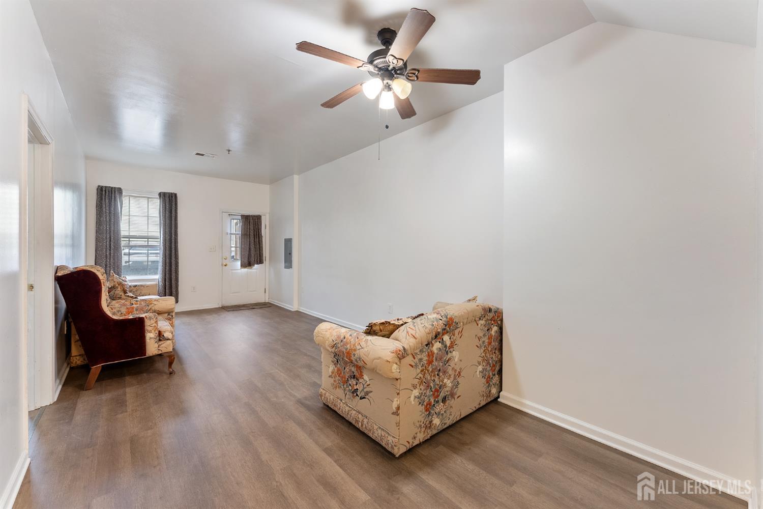 128 Remsen Avenue, Unit A New Brunswick, NJ 08901 - Photo 5 of 18 a living room with furniture and a chandelier