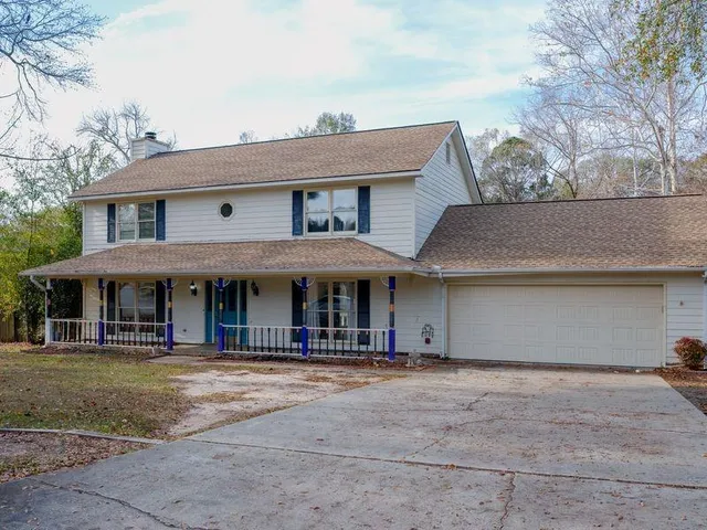 a front view of a house with lots of windows
