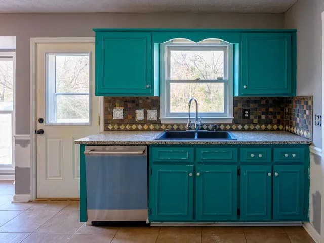 a kitchen with cabinets a window and a sink