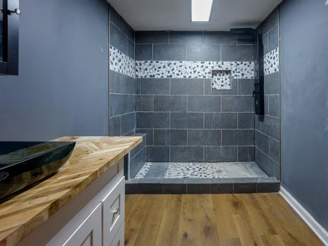 a bathroom with a bathtub and shower