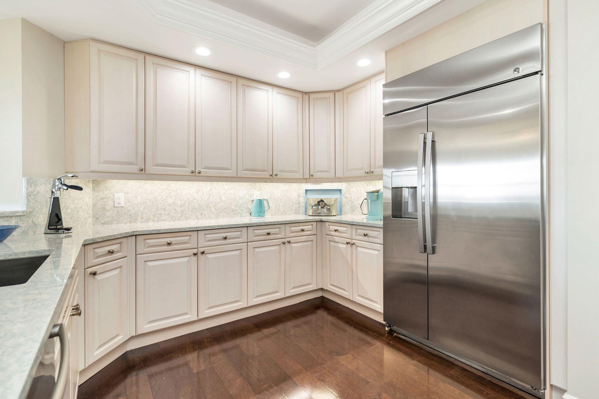 700 Highway 1, Unit 401 Jupiter, FL 33477 - Photo 19 of 39 a kitchen with granite countertop stainless steel appliances a refrigerator sink and cabinets
