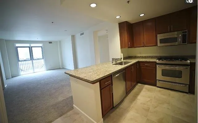 a kitchen with a stove sink and microwave