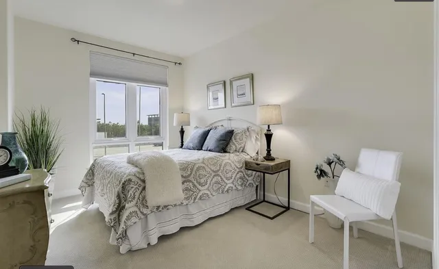 a bedroom with a bed and a chair