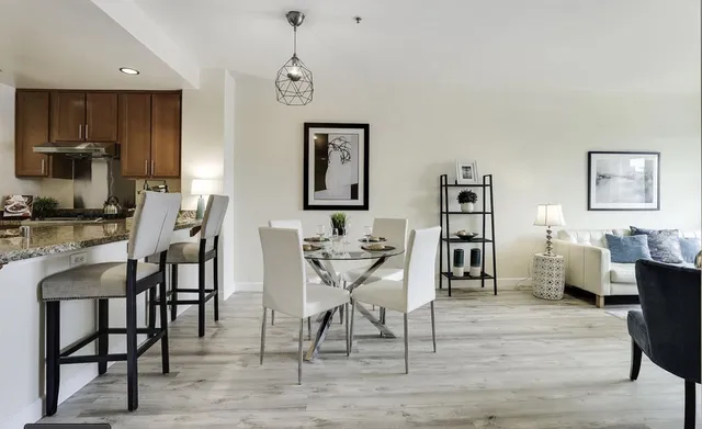 a dining room with furniture and wooden floor