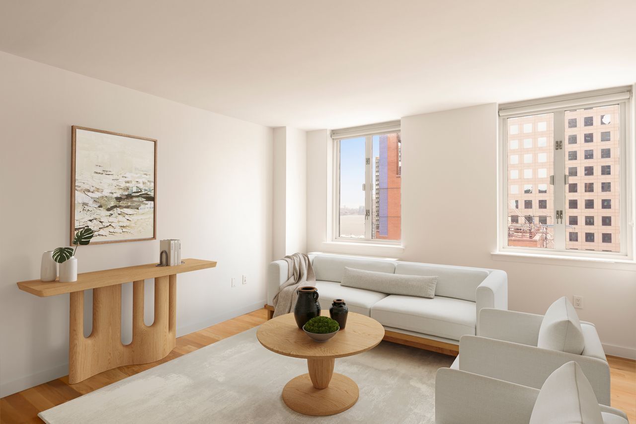 225 Rector Place, Unit 22J Manhattan, NY 10280 - Photo 1 of 8 a living room with furniture and a window