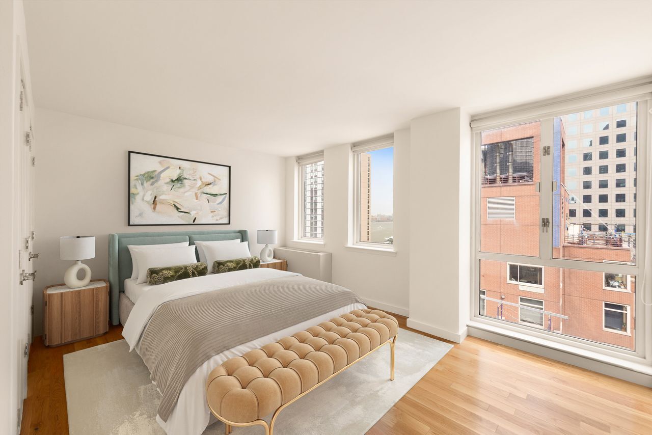 225 Rector Place, Unit 22J Manhattan, NY 10280 - Photo 2 of 8 a bedroom with a large bed and a window