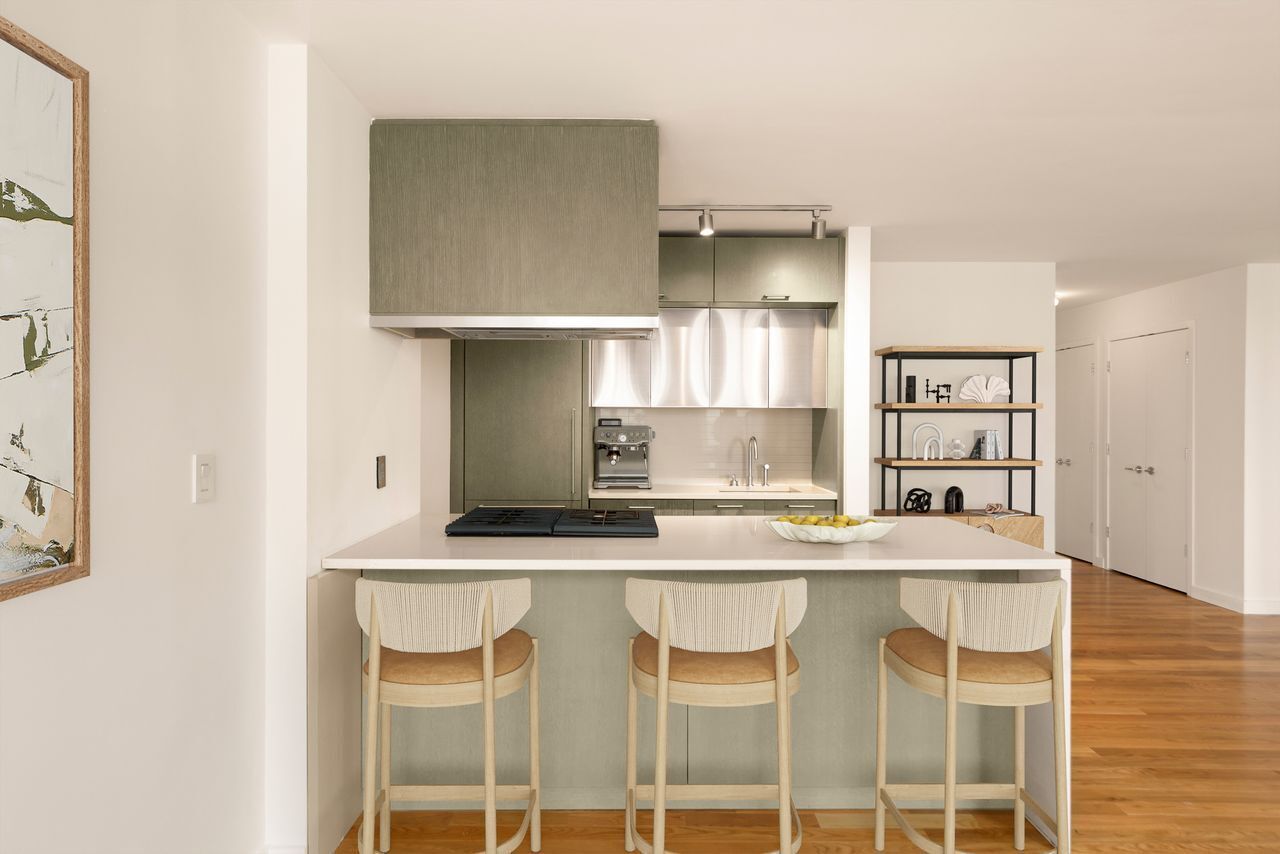 225 Rector Place, Unit 22J Manhattan, NY 10280 - Photo 3 of 8 a kitchen with a dining table and chairs