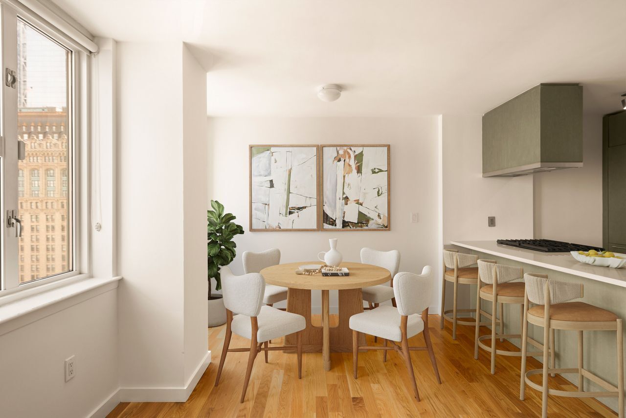 225 Rector Place, Unit 22J Manhattan, NY 10280 - Photo 4 of 8 a view of a dining room with furniture and a window