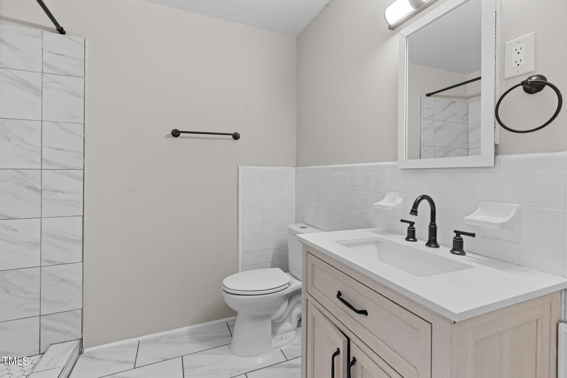 4828 Stafford Drive Durham, NC 27705 - Photo 13 of 22 a bathroom with a sink a toilet and mirror