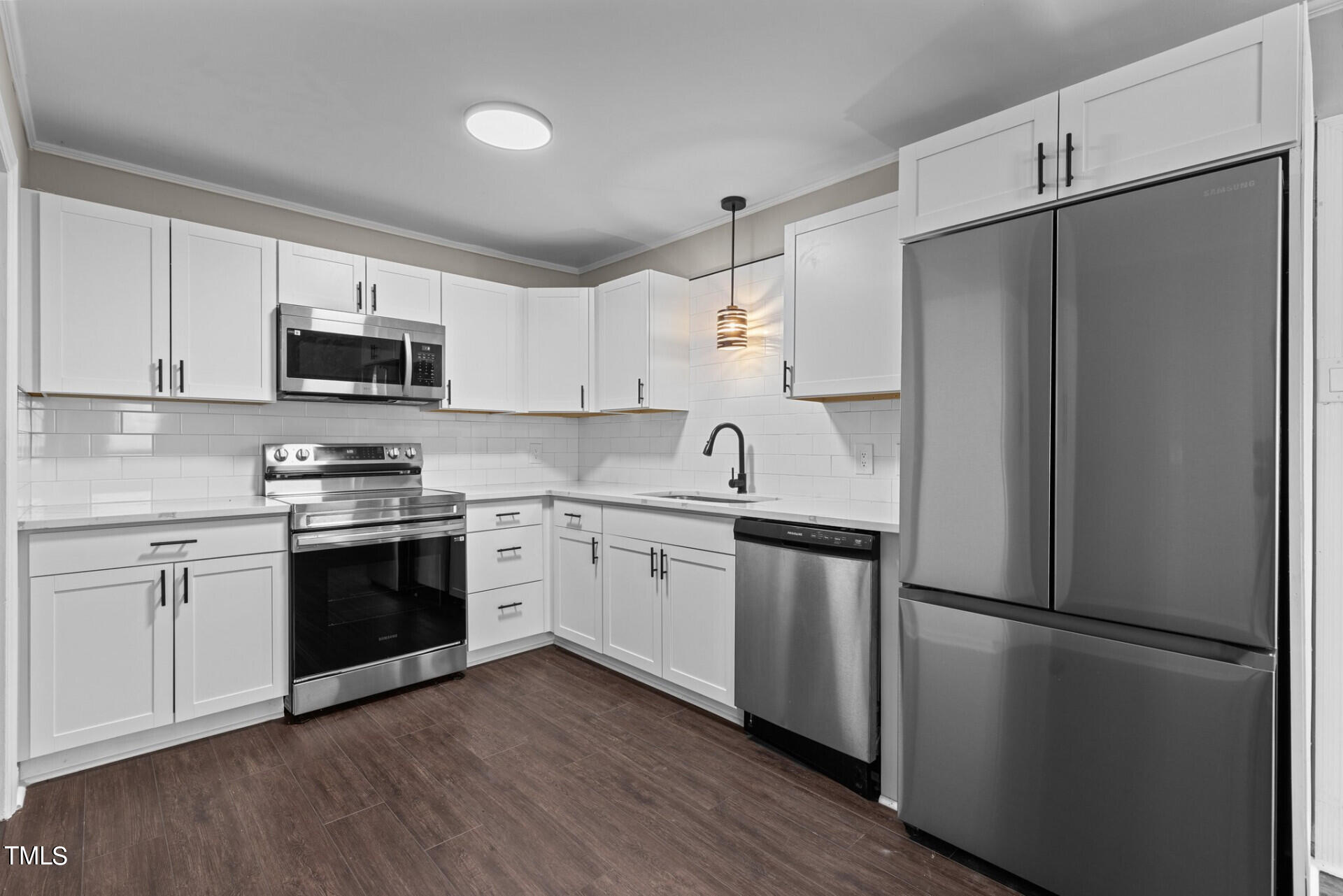 4828 Stafford Drive Durham, NC 27705 - Photo 3 of 22 a kitchen with stainless steel appliances a refrigerator sink and microwave