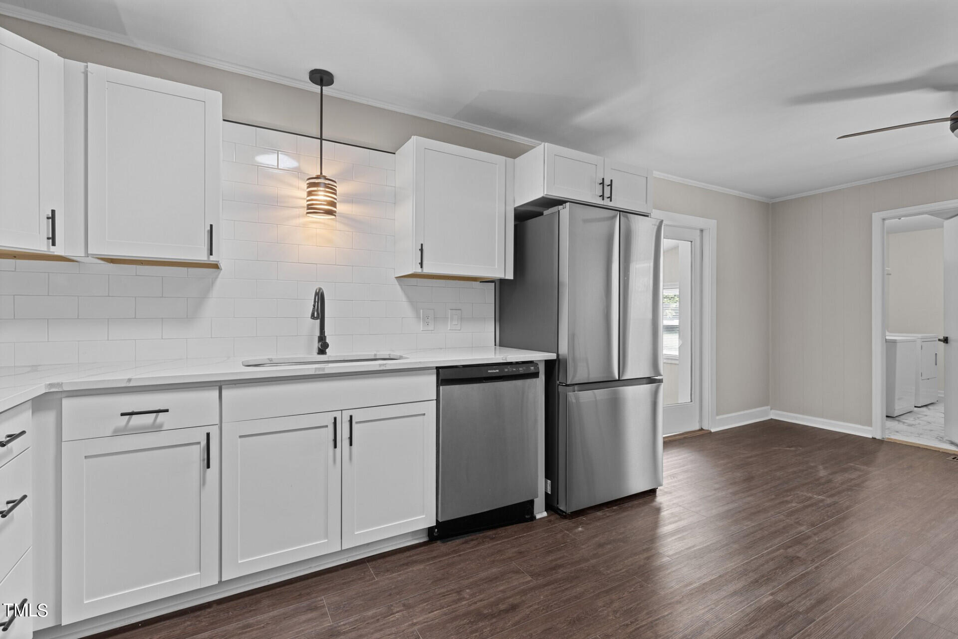 4828 Stafford Drive Durham, NC 27705 - Photo 4 of 22 a kitchen with a refrigerator sink and cabinets