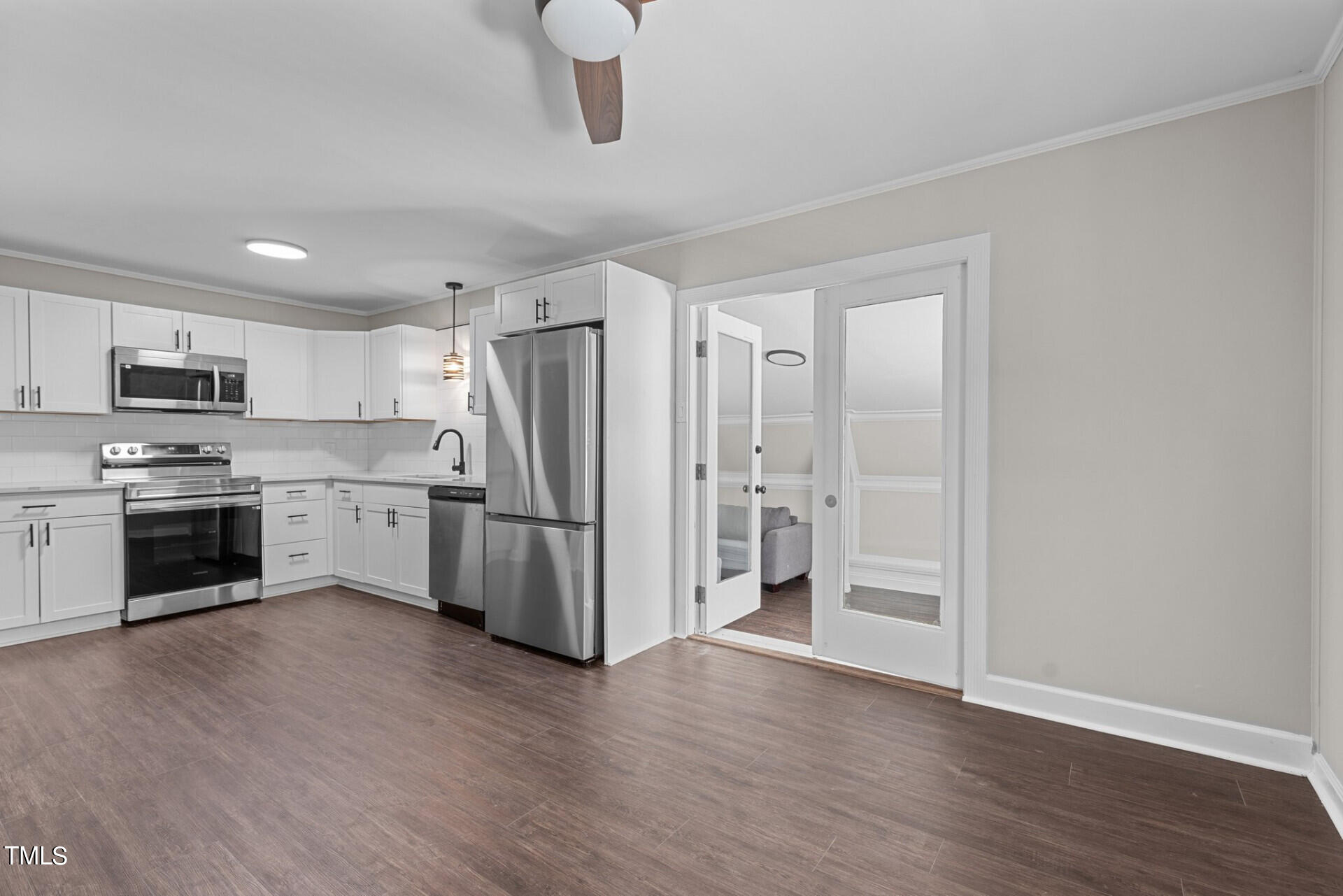 4828 Stafford Drive Durham, NC 27705 - Photo 5 of 22 a kitchen with stainless steel appliances a refrigerator and a stove top oven