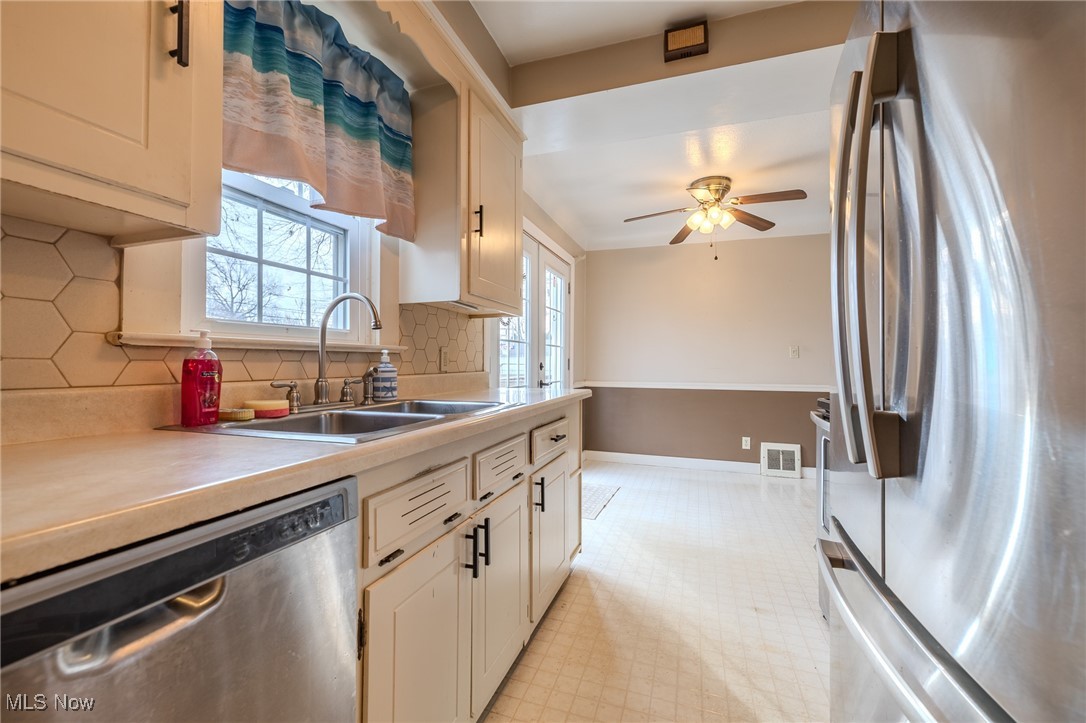 765 Pendley Road Willowick, OH 44095 - Photo 31 of 50 Kitchen featuring tasteful backsplash, ceiling fan, sink, and appliances with stainless steel finishes