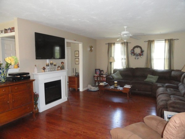 128 Brandy Hill Road Thompson, CT 06277 - Photo 2 of 26 a living room with furniture flat screen tv and a fireplace