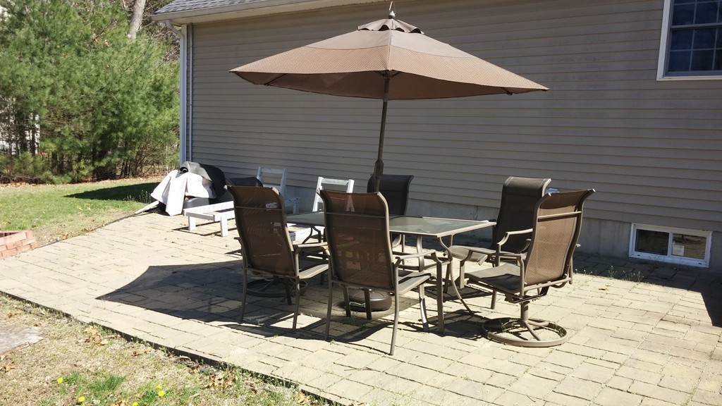 128 Brandy Hill Road Thompson, CT 06277 - Photo 24 of 26 a view of a patio with table and chairs under an umbrella