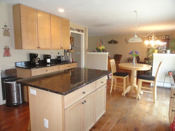 128 Brandy Hill Road Thompson, CT 06277 - Photo 6 of 26 a kitchen with a stove a sink a dining table and chairs