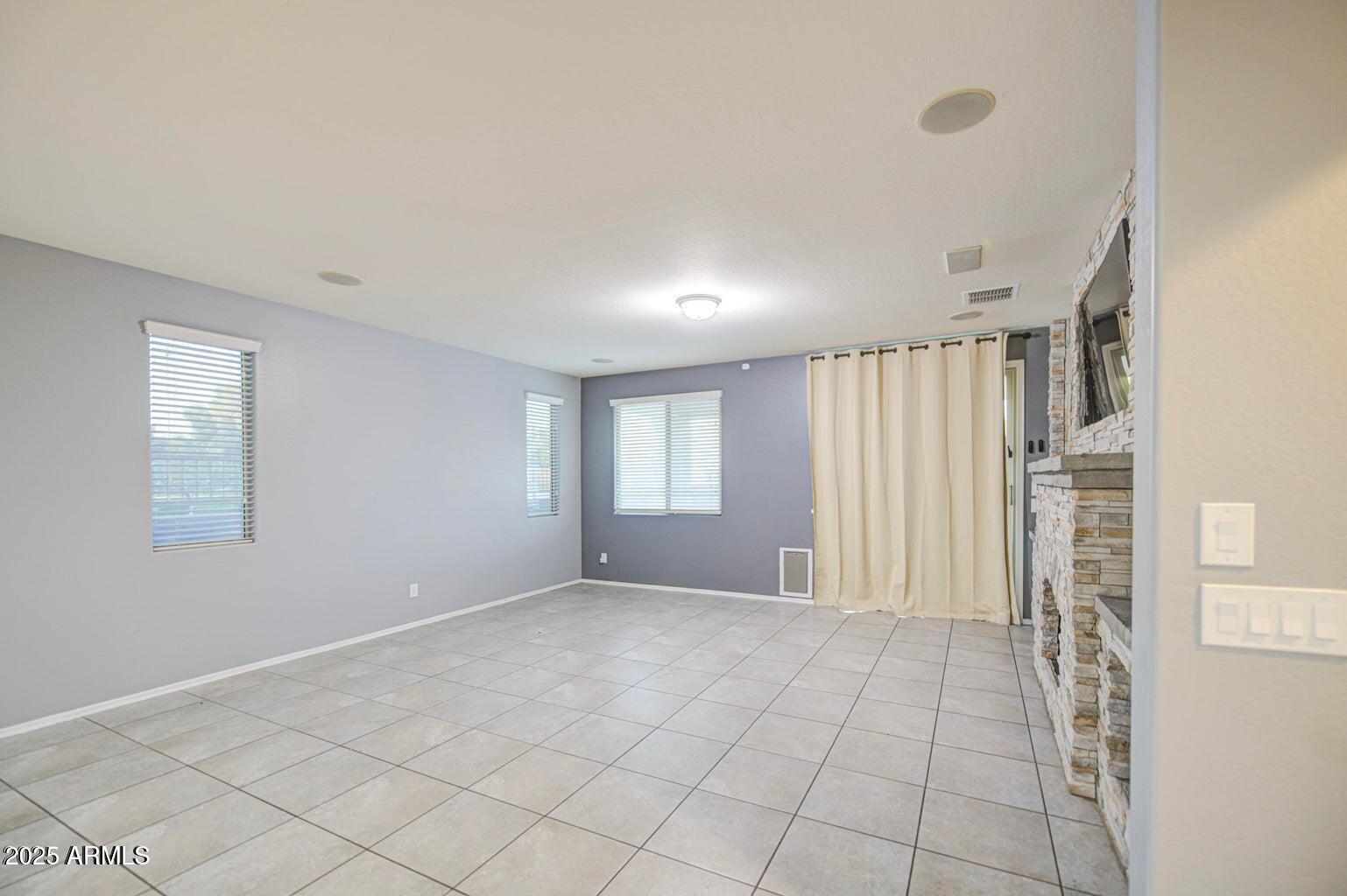 6815 South 19th Lane Phoenix, AZ 85041 - Photo 11 of 40 a view of an empty room with a window