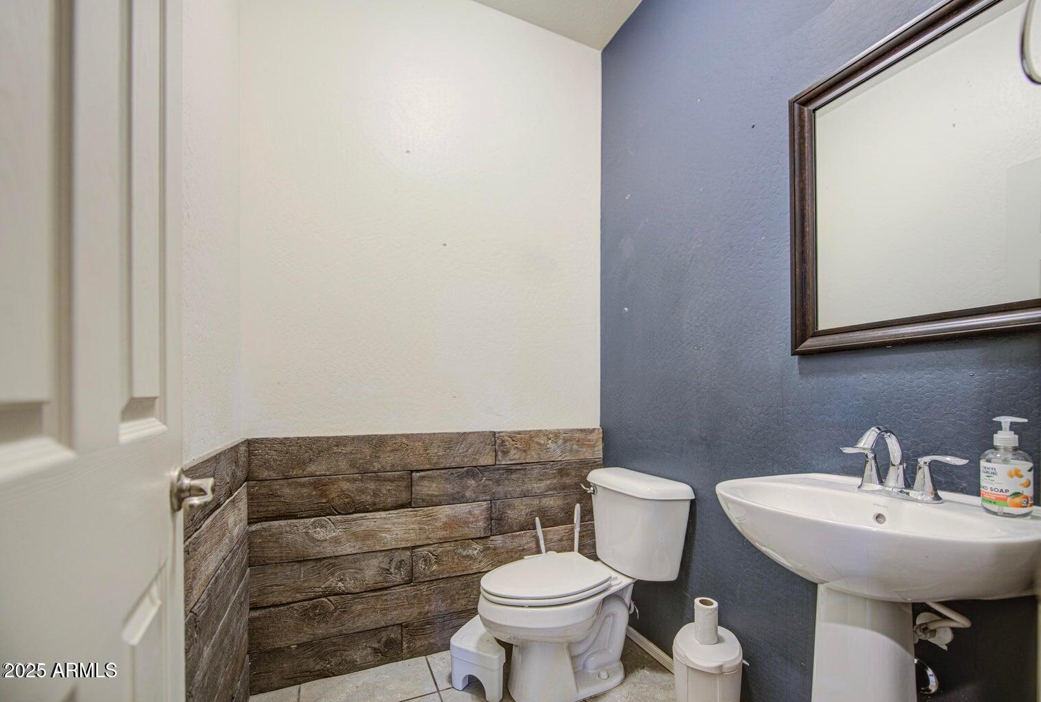 6815 South 19th Lane Phoenix, AZ 85041 - Photo 17 of 40 a bathroom with a sink and a toilet