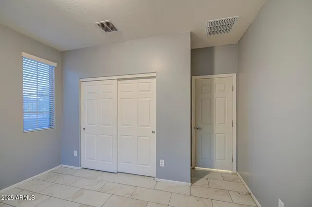 a view of an empty room with closet area