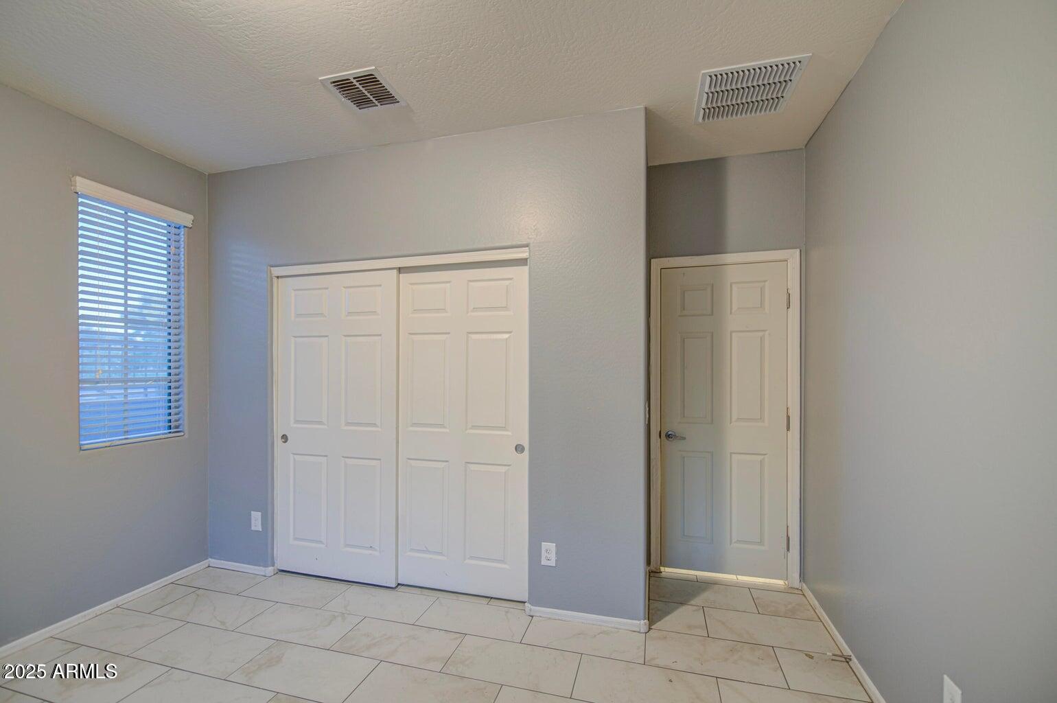 6815 South 19th Lane Phoenix, AZ 85041 - Photo 18 of 40 a view of an empty room with closet area