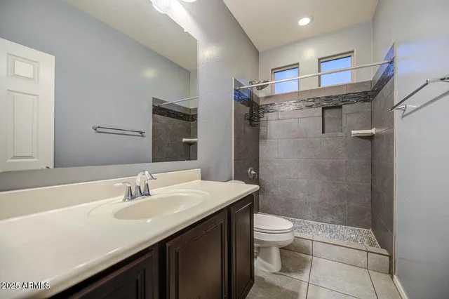 a bathroom with a sink vanity and a mirror
