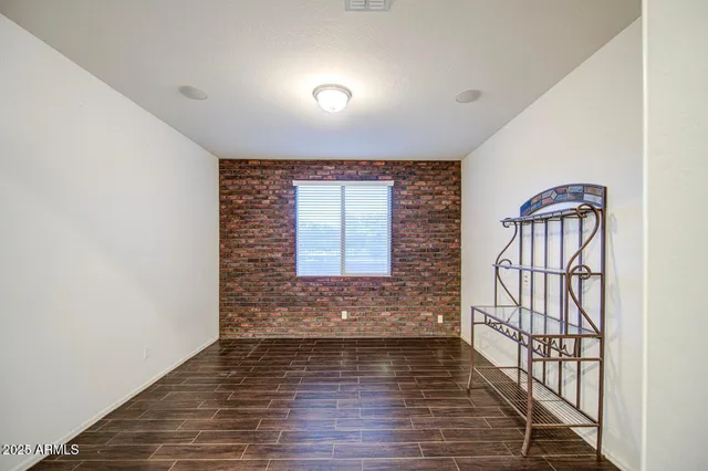 an empty room with wooden floor and door