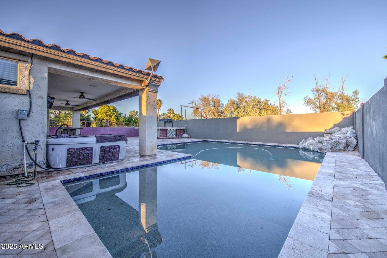 6815 South 19th Lane Phoenix, AZ 85041 - Photo 29 of 40 a view of a balcony with two chairs and a potted plant