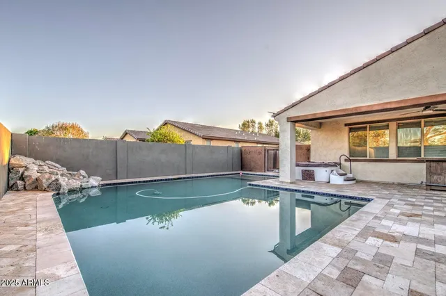 swimming pool view with a seating space
