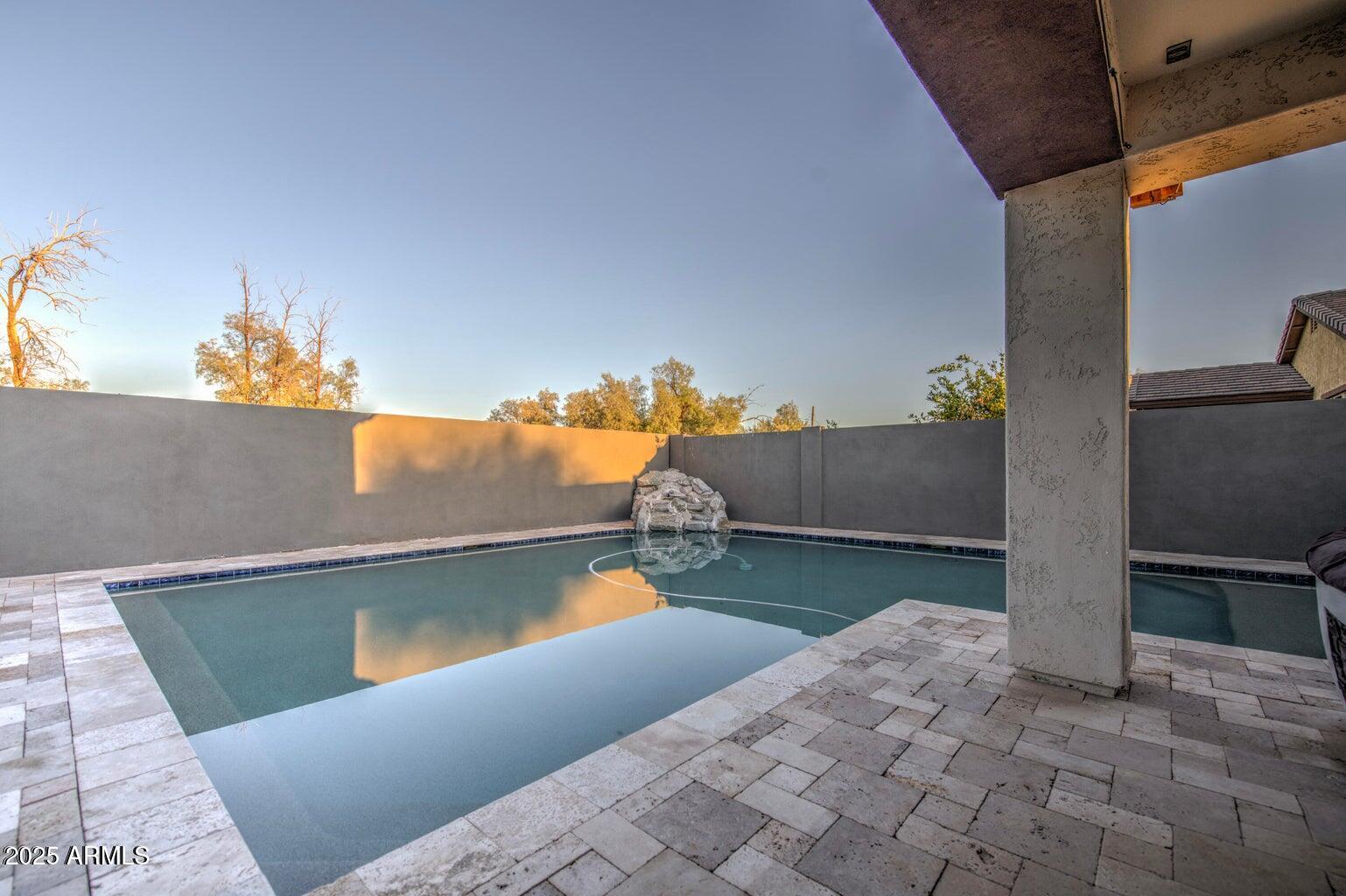 6815 South 19th Lane Phoenix, AZ 85041 - Photo 33 of 40 swimming pool view with a seating space