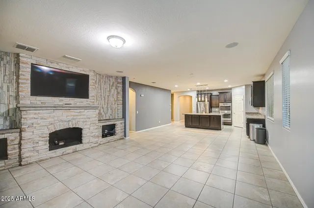 a view of a livingroom with a fireplace and cabinet
