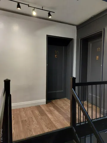 a view of bedroom with a bed and wooden floor