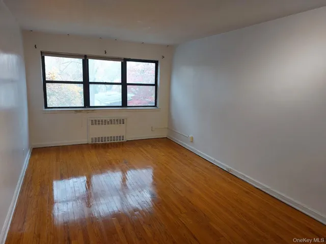 a view of bedroom with wooden floor and closet
