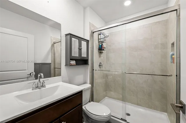 a bathroom with a sink toilet and shower