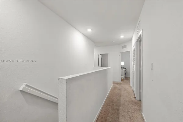 a view of a hallway with white walls