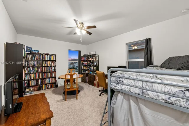a bedroom with bed and a chandelier
