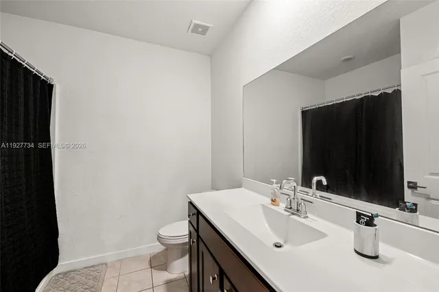 an aerial view of a city with lots of residential buildings and parking space