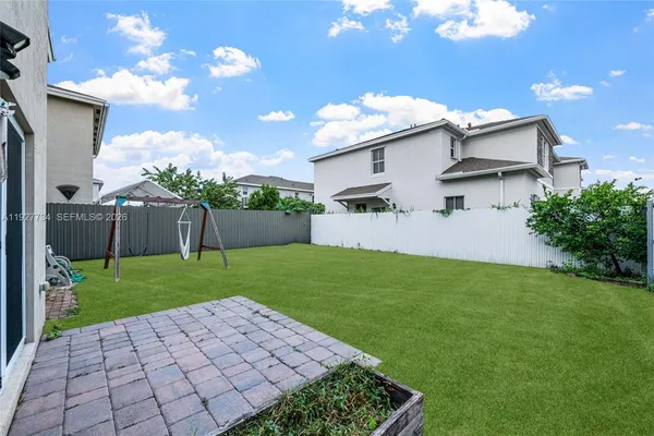 a view of a house with a yard and sitting area