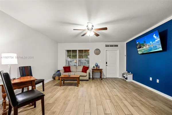 a living room with furniture and a flat screen tv
