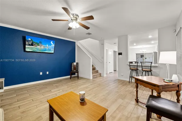 a view of a livingroom with furniture and a kitchen