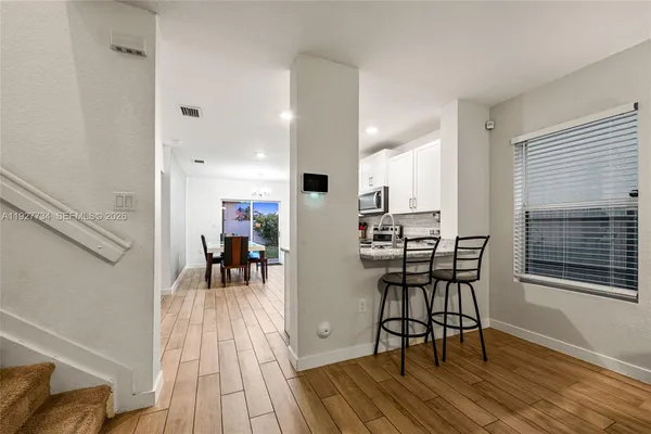 a view of a dining room with furniture and wooden floor