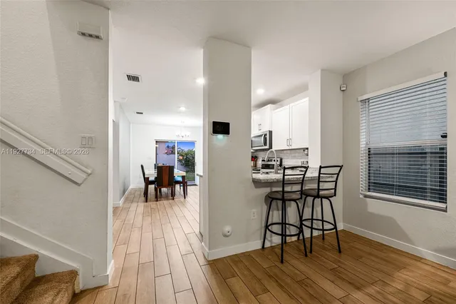 a view of a dining room with furniture and wooden floor