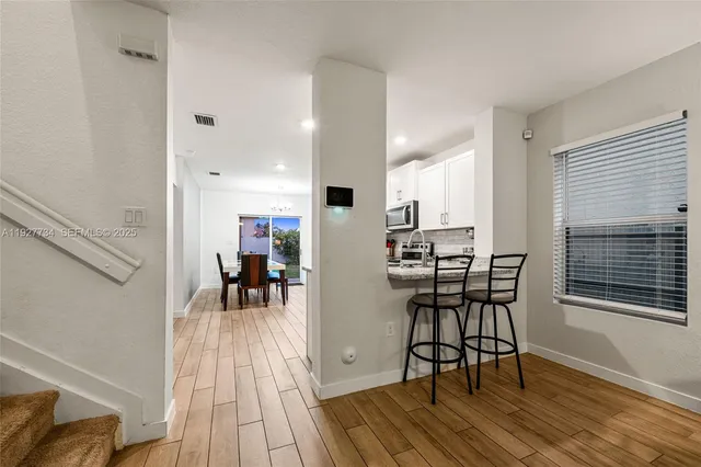 a view of a dining room with furniture and wooden floor