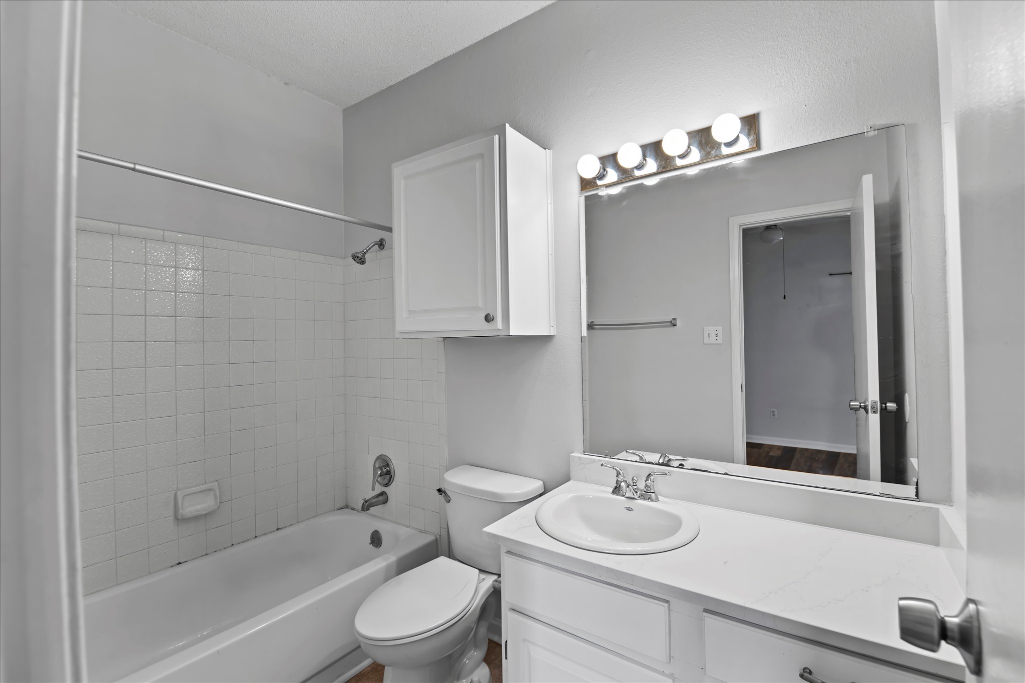 12166 Metric Boulevard, Unit 233 Austin, TX 78758 - Photo 9 of 13 a bathroom with a sink vanity granite toilet tub and shower