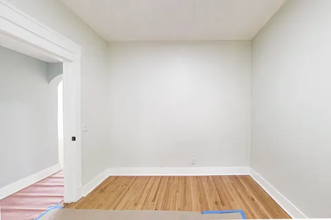 a view of a room with wooden floor and small space