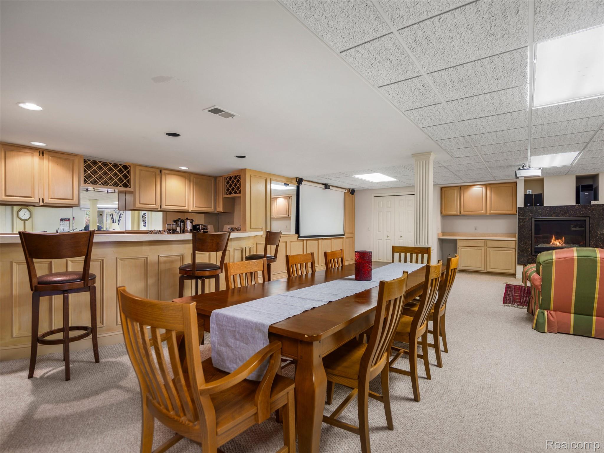 5724 Murfield Drive Rochester, MI 48306 - Photo 95 of 99 Dining area with light carpet, a fireplace, and a drop ceiling