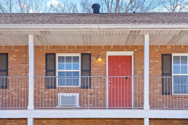 a view of a brick house with large windows