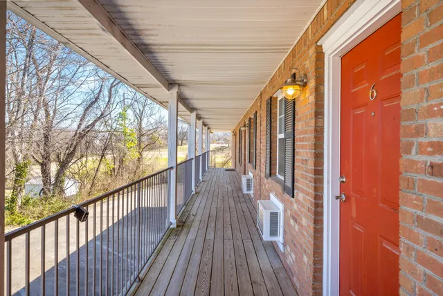 a view of balcony with wooden floor