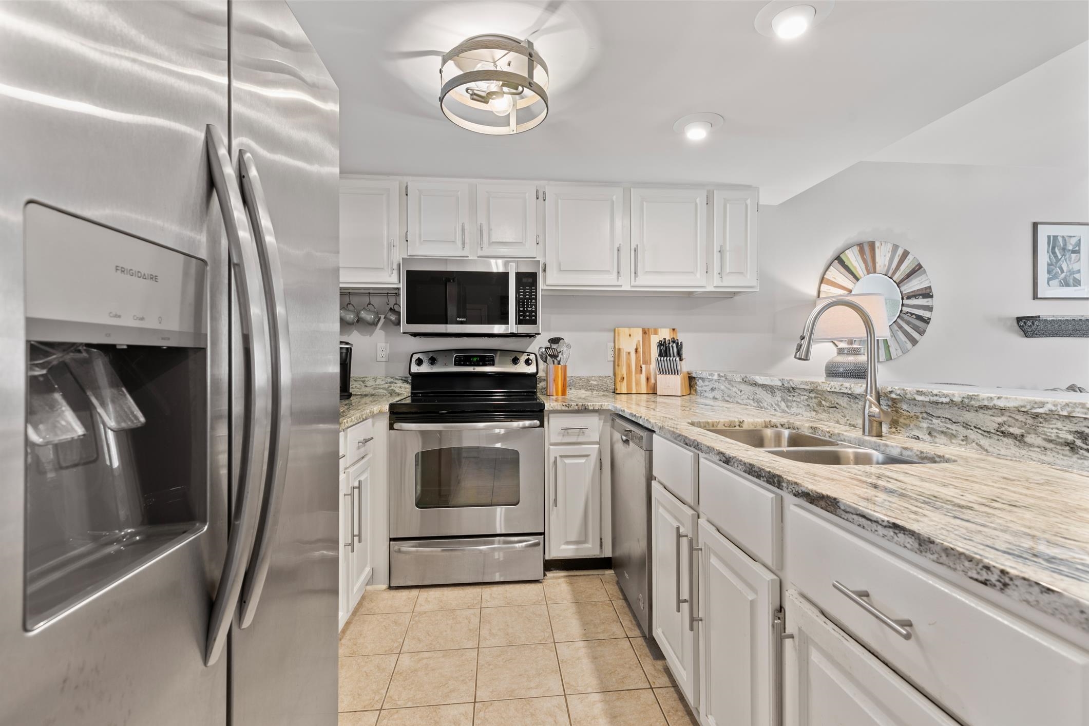 200 16th Street, Unit 202A St. Augustine, FL 32080 - Photo 13 of 39 a kitchen with a sink cabinets and stainless steel appliances